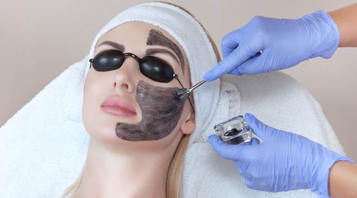 Carbon face peeling procedure in a beauty salon.